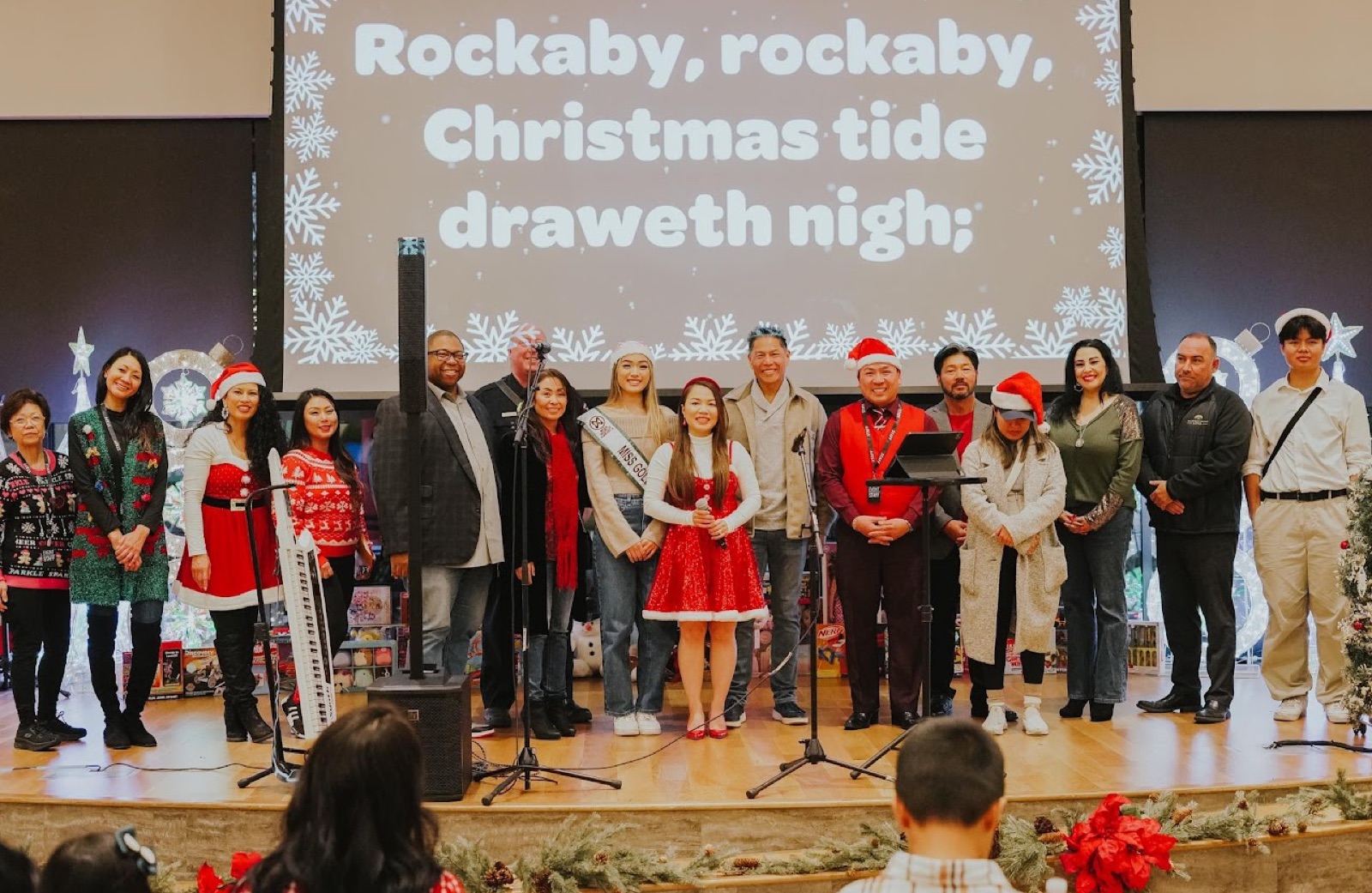 cPALSs board, volunteers, and pageant titleholders on stage at the Elk Grove Toy Drive Celebration